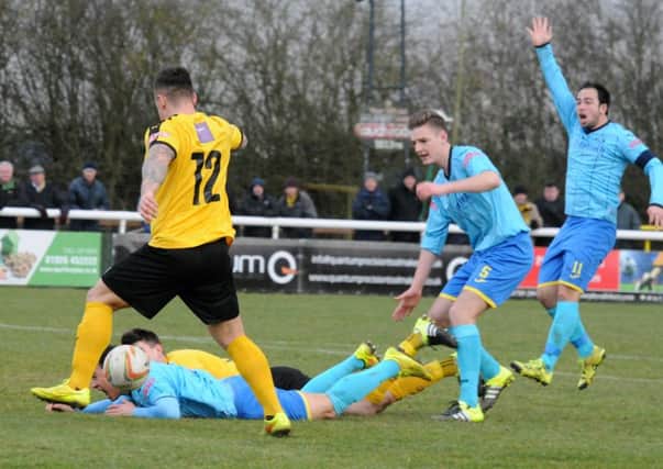 Sam Gaughran appeals for a free-kick as Ben Mackey prepares to slot home Leamington's equaliser. Picture: Morris Troughton