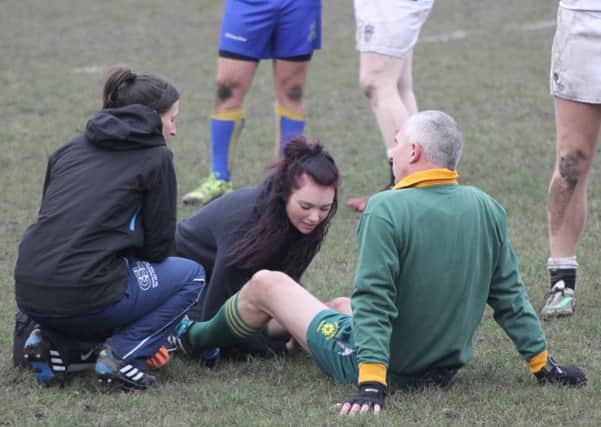 The referee receives treatment for a leg injury during the first half of Kenilworth's clash at Burton. Picture: Willie Whitesmith