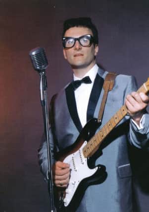 Win tickets to Buddy Holly show.