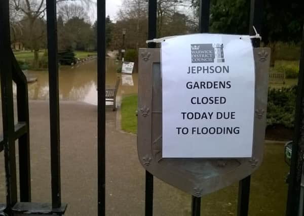 A notice to the public with a flooded Jephson Gardens in the background.