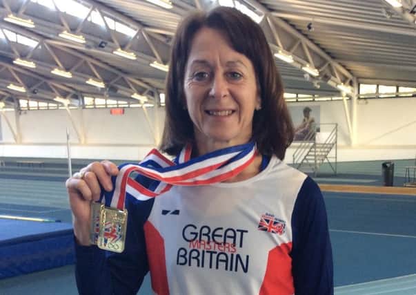 Leamington C&AC's Susie Tawney shows off her masters golds at the Lee Valley Athletics Centre.