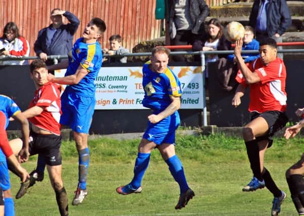 Jack Edwards and Richard Taundry try and get on the end of a ball into the Redditch box, with the ball appearing to strike a home hand. Picture: Sally Ellis