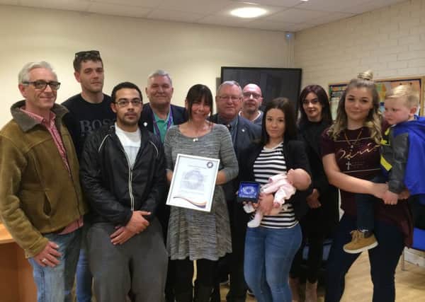 Members of Sam's family pictured with Community Safety Partnership representatives at the presentation. NNL-161104-112521001