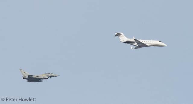 The Challenger 300 D-BTLT private plane is escorted by the two Typhoon jets into Cardiff. Photo by Peter Howlett.