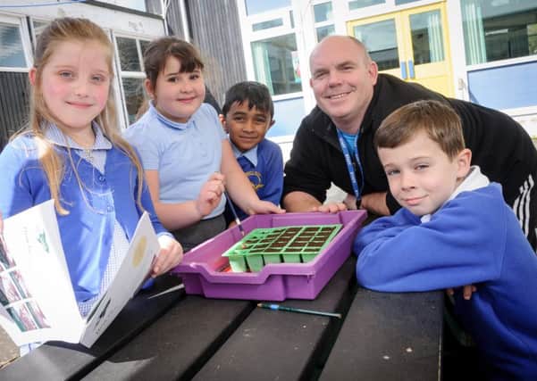 Pictured: Class Teacher Karl Robinson, together with year 3 pupils NNL-160419-205350009