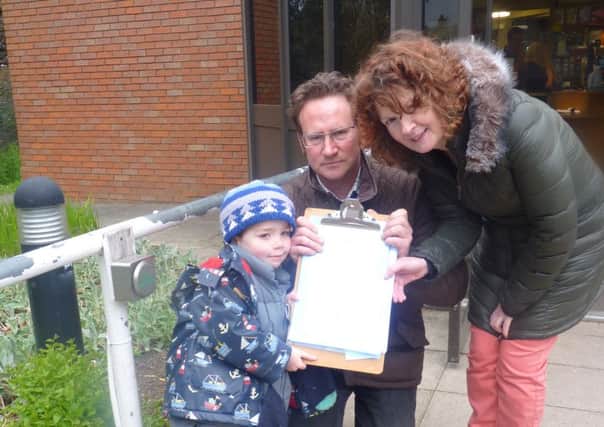 Oscar Sternberg handing the petition to Cllr. John-Paul Bromley (Lab, Saltisford) and Cllr. Jackie D'Arcy (Lab, Emscote) outside St Nicholas Park Leisure Centre