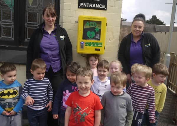 Youngsters and staff at Banana Moon nursery in Harbury where a public AED has been installed