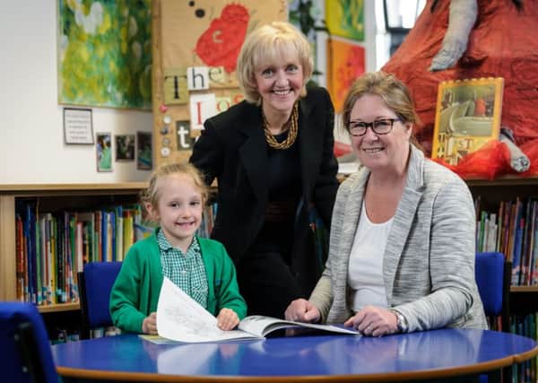 Left to right: Six-year-old Emily Biernacka, headteacher Catherine Crisp and Every Child a Reader manager Sue Postlethwaite.