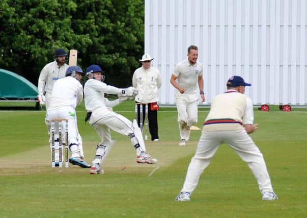 Knowle & Dorridge batsman Alex Phillips drives a Jonathan Wigley delivery towards the boundary. Picture: Morris Troughton
