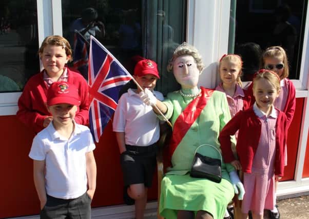 Thorns Infant School pupils with the PTA's scarecrow - the Queen