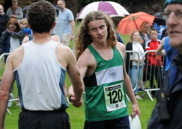 Kenilworth Runners' Stan Doxey receives congratulations after finishing.