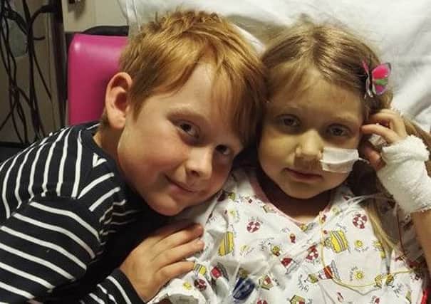 Eleanor with her brother, Thomas, after the operation. NNL-160615-111628001