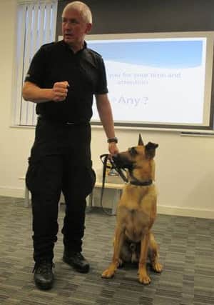 PC John Hankinson demonstrating handling techniques with his police dog Rio.