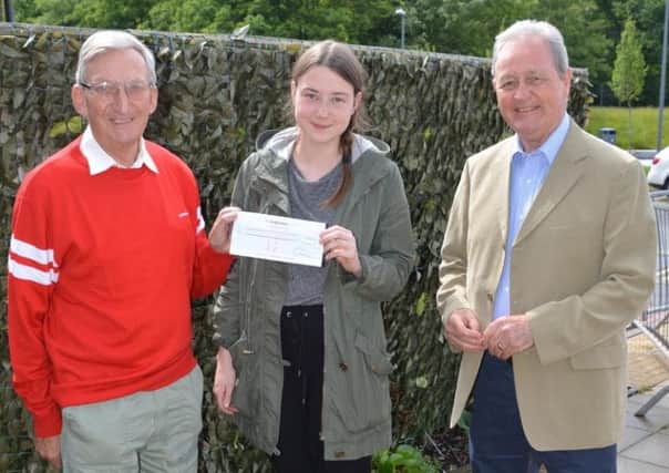 Peter Tolan and Pat Reddin present the Catenian Bursary Fund cheque to Brogan Stewart.
