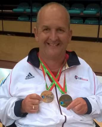 Nigel Murray shows off his World Open medals