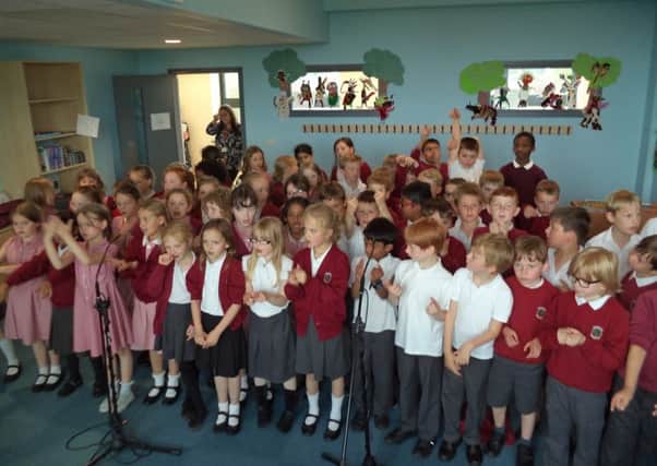 Children at Paddox School record music for their very own CD.