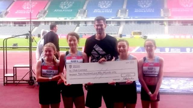 Great Britain high jumper Robbie Grabarz presenting a Club Connect cheque for Â£250 to Rugby's winning U13s girls' relay team