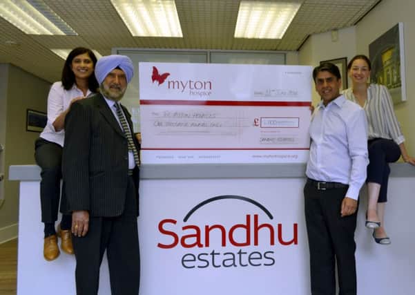 Sandhu Estates managing partners (Mohan and Kam Sandhu) present the Â£1,000 donation to Hannah Morris of Myton Hospices.