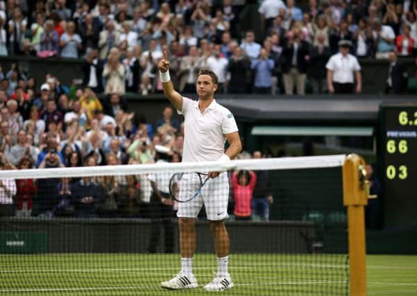 Marcus Willis acknowledges the crowd after his defeat to Roger Federer.