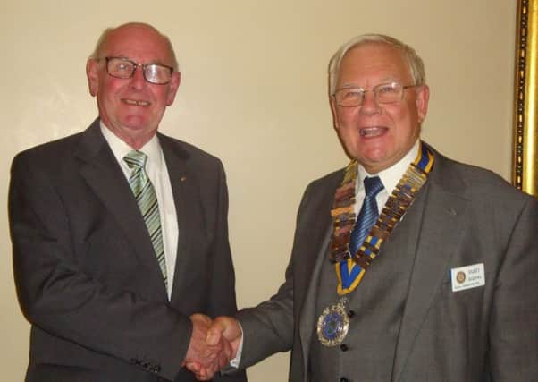 Former Rotary Club of Royal Leamington Spa president Barry Frith welcomes new president Barry Andrews at the club's annual handover meeting.