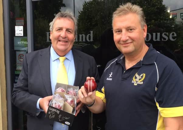 Richard Thornton, joint senior partner of Leamington solicitors Blythe Liggins, and Paul Smith, receiving the balls on behalf of Kenilworth Wardens, where he is head of cricket.