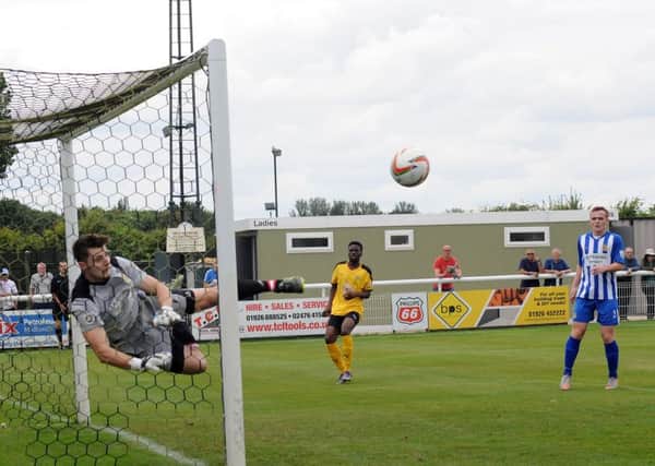 Nick Draper acrobatically stops Tom James (out of picture) opening the scoring for Brakes. Pictures: Morris Troughton