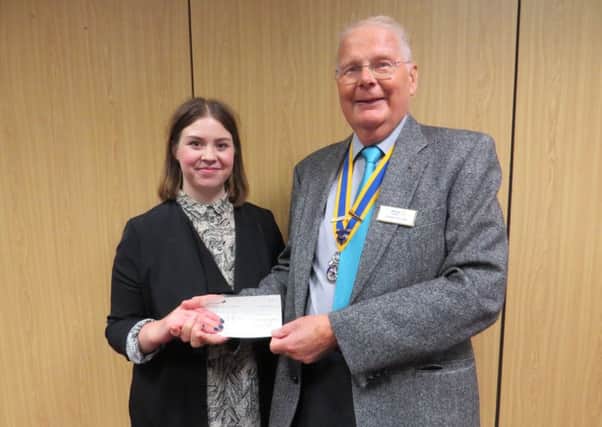 Rotary President John Taylor presented Emma with a cheque towards the charity's work.