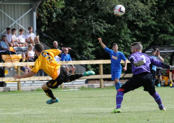 Jamie Smith is sent tumbling by Bolehall's Tom McNulty on Saturday, a challenge that earned the Swifts keeper a red card. Picture: Morris Troughton