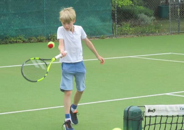 A youngster takes part in a Try Tennis session at Warwick Boat Club.