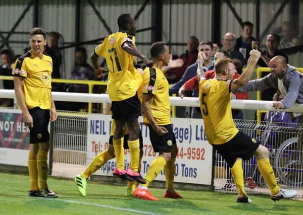 Leamington players rush over to celebrate with the home fans after James Mace's last-minute winner (below). Pictures: Tim Nunan