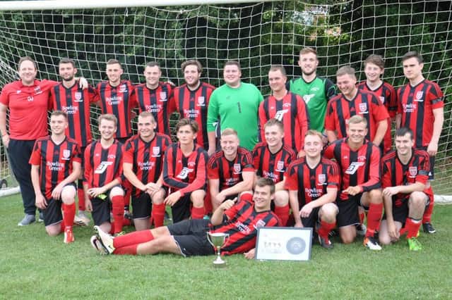 Stockton FC celebrate winning the Nathan Rhodes Memorial Match. Nathan's brother Simon is pictured at the front wiht the trophy.