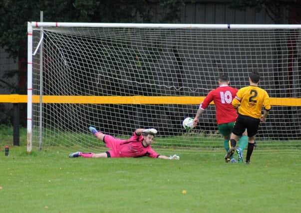 Ben Mackey slots home his 15th-second opener on his way to a hat-trick against Racing Club. Pictures: Morris Troughton
