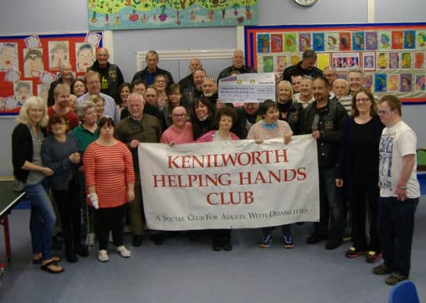 Members of Kenilworth Helping Hands and Antelope Motorcycle Club with a cheque for Â£1,000