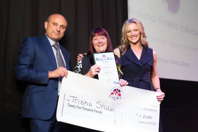 Trisha Shaw collects her award from Chris McElligott and Gabby Logan.