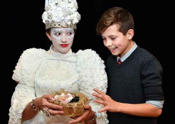 Becca Shaw as the White Witch tempts Joseph Jones, who plays Edmund.