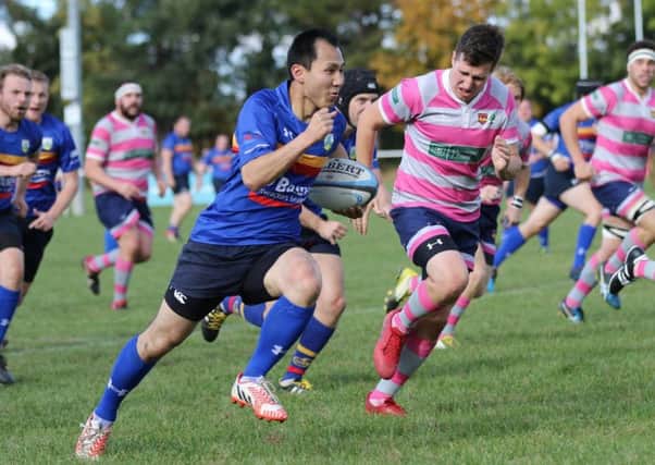 Kenny Kwok races away to score Leamington's opening try against Olney.