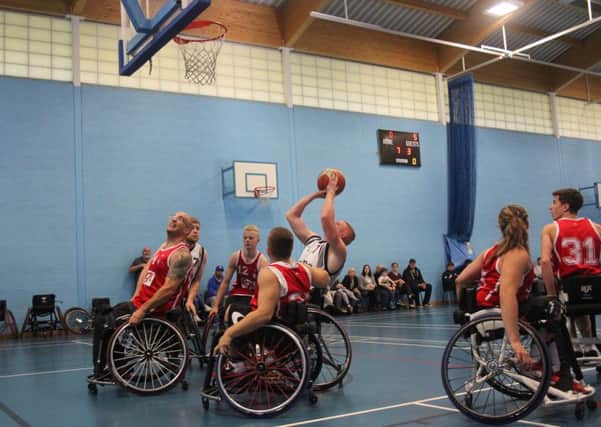 Dan Gill shoots under pressure for Warwickshire Bears, while below, Siobhan Fitzpatrick goes for a basket. Pictures submitted