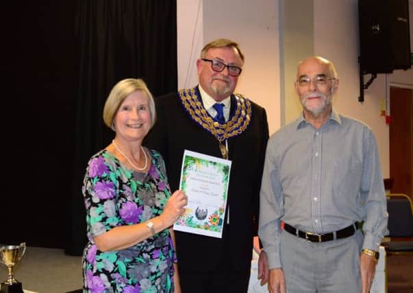 Barbara and Mervyn Tyndall (left and right), with mayor Cllr Richard Davies (centre). The pair won trophies in the Large Front Garden and Medium Back Garden categories