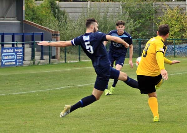 Ryan Rowe curls home Leamington's match-winning goal under pressure from Tom Ward. Pictures: Sally Ellis