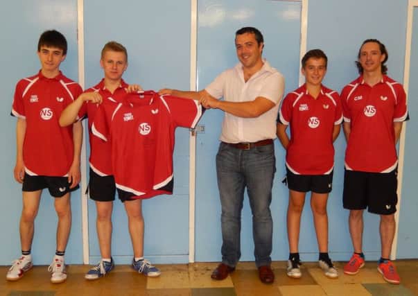 Free Church squad members Adam Cofler, Lewis Singleton and Jack Green and director of coaching Chris Mulligan present a team shirt, signed by England number one Kelly Sibley, to Rob Smith, sales manager of team sponsors NS Optimum. Picture submitted