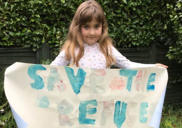 Charlotte Dubber, 8, with her 'Save the Refugees' banner