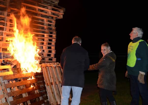 Warwick Town Mayor Christine Cross lighting the bonfire. Photo by Gillian Fletcher.