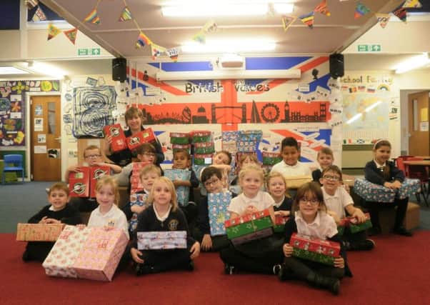 Pupils with some of their shoeboxes. NNL-160811-125423001