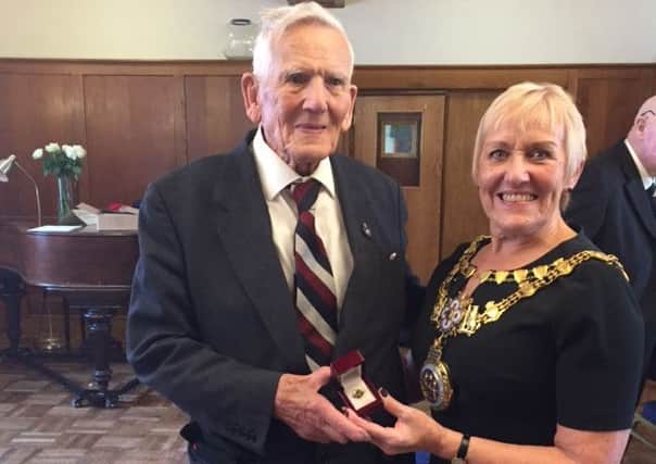 War veteran Bryan Johnson receiving a special edition poppy pin from Warwick Mayor Christine Cross in apprecatation for his dedication to his town and country.