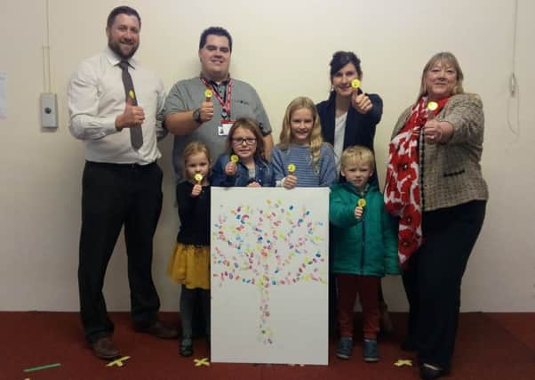 The anti-bullying tree with Milverton children's thumbprints on it. Back row from left to right: Matt Fisher (headteacher), Ben Donagh, Christine Mabel and Deborah Miller (Senior victim service manager for Warwickshire). Front row from lefgt to right: Milverton pupils Eliza, Charlotte, Elle and Magnus.