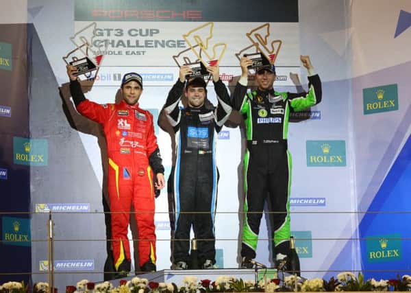 Tom Oliphant takes his place on the far right of the podium after third place in his opening Porsche GT3 Cup Challenge Middle East outing.