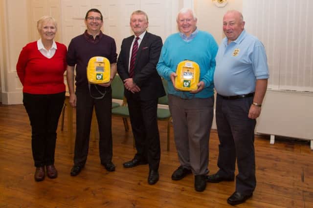 Rosemarie Geden (Rugby Police BC), Gary Tubb (Oakfield BC), Martin Render (Community Heartbeat), Rodger Sirett (Grange BC) and Dave Owen (Rugby Police BC) with the two defibrillators