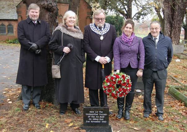 The new gravestone in Oaks Cemetery commemorating the unknown victims of the Abbey End landmine explosion. From left to right: Gordon Cain, Cllr Pat Cain, town mayor Richard Davies, town clerk Maggie Field and deputy town clerk Neil Eaton. Photo by Robin Leach