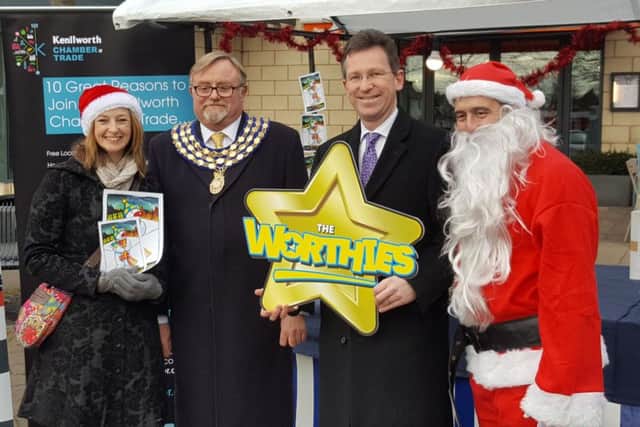 The launch of the 'Buy one Present in Kenilworth' campaign at the Chritsmas market in Abbey End on Saturday December 3. From left: Seánna Holland, Kenilworth mayor Cllr Richard Davies, Jeremy Wright MP and Cllr Richard Hales.