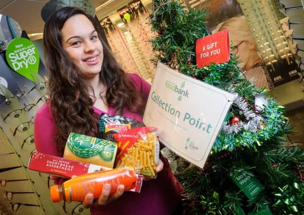 Specsavers in Kenilworth is encouraging customers to drop off non perishable food in their food bank during the run up to Christmas.  Pictured: Ambreena Bhatti NNL-160612-194925009
